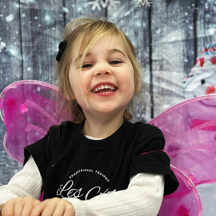 4-year-old girl performing a song with snowy background